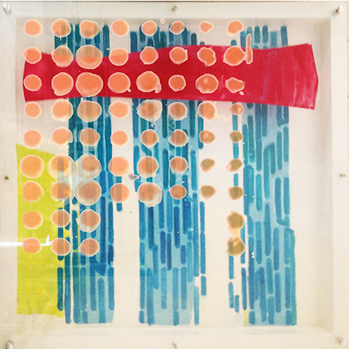A picture of an art piece with orange and blue circles.